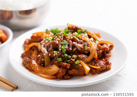 Korean stir fried spicy pork (Bulgogi) with cooked rice and kimchi on white background Korean stir fried spicy pork (Bulgogi) with cooked rice and kimchi on white background 130551593