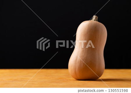 Fresh butternut squash pumpkin on orange and black background 130551598