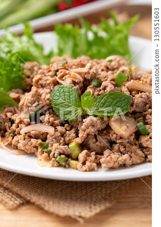 Local Thai food, Spicy minced pork salad (Larb Moo) eating with fresh vegetables  130551603