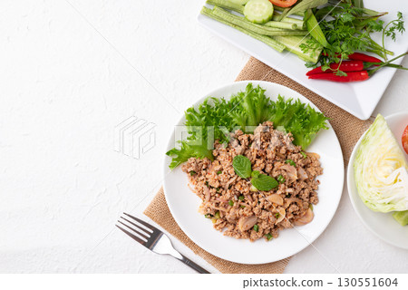 Local Thai food, Spicy minced pork salad (Larb Moo) eating with fresh vegetables on white background 130551604
