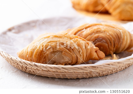 Thai Curry puff stuffed with chicken or sweet potatoes in basket on white background 130551620