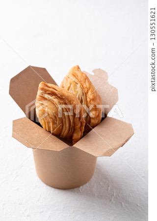 Thai Curry puff stuffed with chicken or sweet potatoes in paper food box on white background 130551621