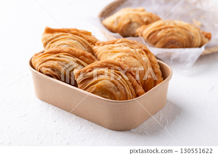 Thai Curry puff stuffed with chicken or sweet potatoes in paper food box on white background Thai Curry puff stuffed with chicken or sweet potatoes in paper food box on white background 130551622
