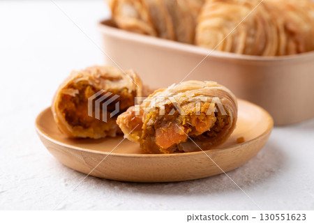 Curry puff stuffed with curry chicken on wooden plate, Thai snack food style 130551623