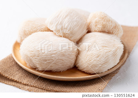 Lion's Mane mushroom or Yamabushitake mushroom on wooden plate Lion's Mane mushroom or Yamabushitake mushroom on wooden plate 130551624