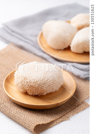 Lion's Mane mushroom or Yamabushitake mushroom on wooden plate Lion's Mane mushroom or Yamabushitake mushroom on wooden plate 130551625