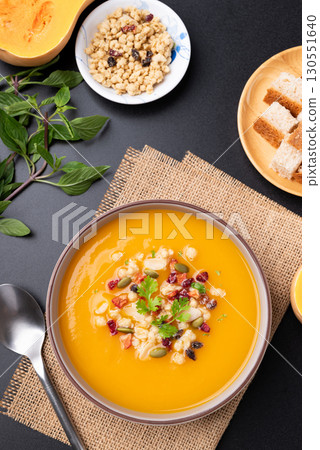 Butternut squash pumpkin soup in a bowl on black background, Homemade food in autumn season 130551640