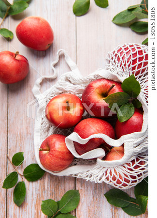 Fresh red apples in reusable shopping bag promoting sustainable lifestyle Fresh red apples in reusable shopping bag promoting sustainable lifestyle 130551806