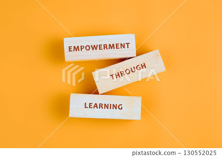 The message connect through learning. EMPOWERMENT THROUGH LEARNING assembled from blocks on orange background, top view The message connect through learning. EMPOWERMENT THROUGH LEARNING assembled from blocks on orange background, top view 130552025