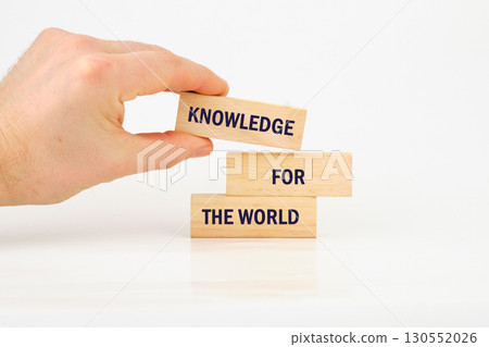 Business, success, idea, learning, planning, Education concept. KNOWLEDGE FOR THE WORLD made from blocks with hand on white background 130552026