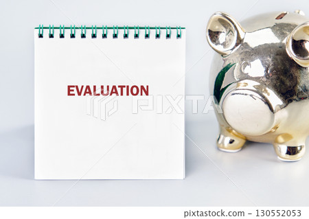 EVALUATION word written in a notebook on a light background. Business risk management concept 130552053