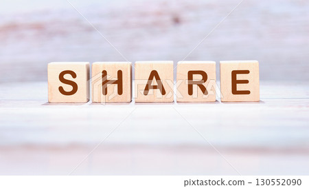 The concept word SHARE is made of wooden cubes on a light background. Technology, website concept 130552090
