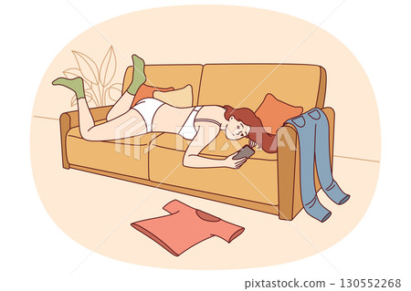 Lazy woman in underwear lies on sofa and uses phone, not paying attention to chaos in apartment Lazy woman in underwear lies on sofa and uses phone, not paying attention to chaos in apartment 130552268