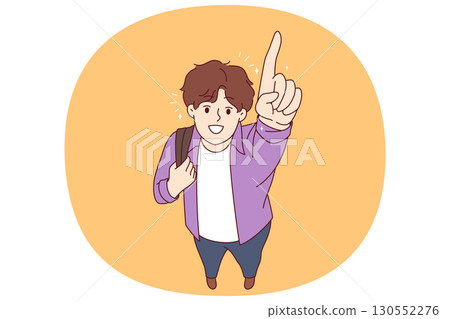 Happy college student pointing finger up and smiling, holding backpack on shoulder 130552276