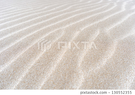 Close-up detail of natural patterns on sand dune surface Close-up detail of natural patterns on sand dune surface 130552355
