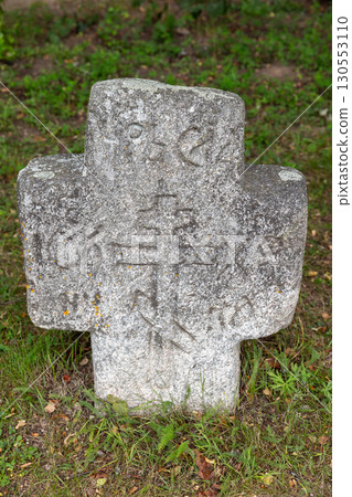 Vasilevo, Russia. A historic stone cross marker featuring intricate carvings 130553110
