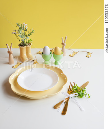 Happy Easter. Easter celebration concept. Top view vertical empty white and yellow plate, Easter egg 130553278