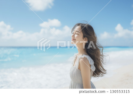 Woman in her 20s, blue sea beach, portrait 130553315