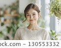 Woman in her 20s, garden center, portrait, looking at camera 130553332