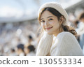 Portrait of a female stadium spectator in her 20s looking at the camera 130553334