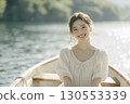 Portrait of a woman in her 20s riding a rowboat, looking at the camera 130553339