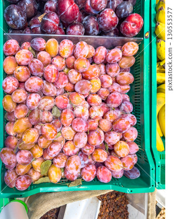 Juicy plums of the "Kabardinka" variety on the counter 130553577