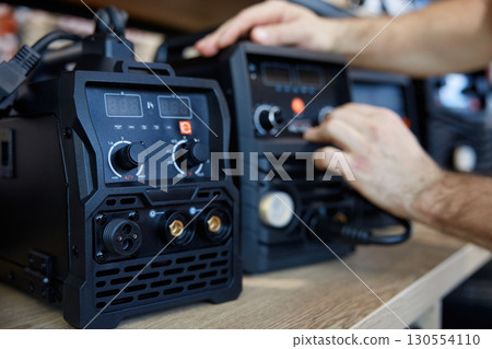 A person is diligently checking a new welding machine 130554110