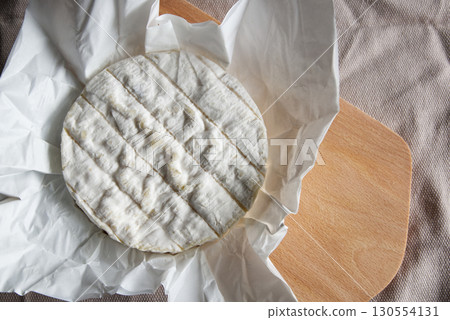 Camembert cheese, a soft and creamy cheese of French origin Camembert cheese, a soft and creamy cheese of French origin 130554131