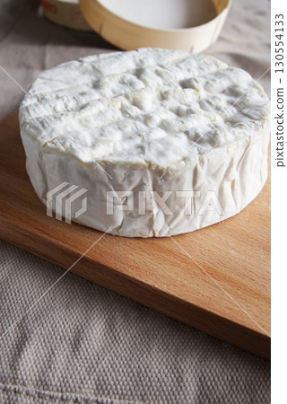 Camembert cheese, a soft and creamy cheese of French origin Camembert cheese, a soft and creamy cheese of French origin 130554133