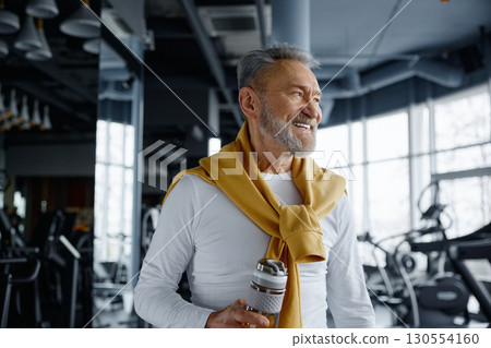 Portrait of a senior man in the gym holding a water bottle 130554160