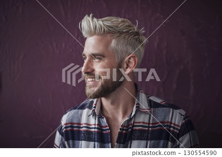 Man with platinum blonde hair and plaid shirt smiling. 130554590