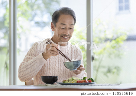 A man in his 60s eating 130555619