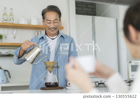 A man in his 60s making coffee 130555622
