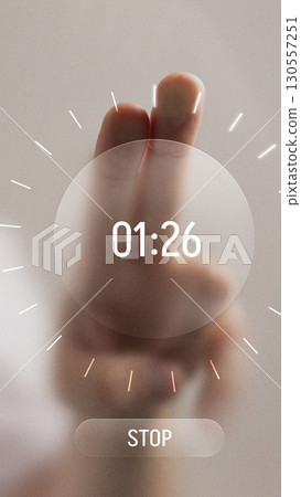 Bold digital artwork. Hand with two fingers pressing futuristic digital timer interface showing countdown 130557251
