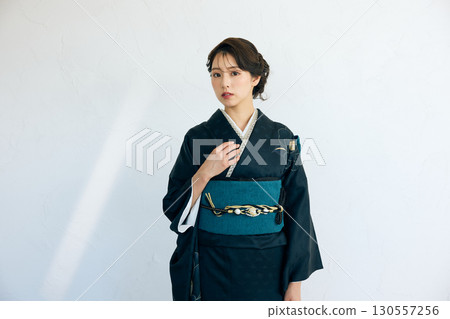 Portrait of an elegant woman wearing a black furisode Portrait of an elegant woman wearing a black furisode 130557256