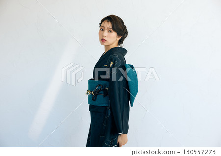 Portrait of an elegant woman wearing a black furisode 130557273