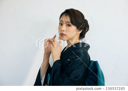 Portrait of an elegant woman wearing a black furisode Portrait of an elegant woman wearing a black furisode 130557285