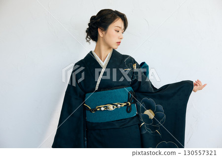 Portrait of an elegant woman wearing a black furisode Portrait of an elegant woman wearing a black furisode 130557321