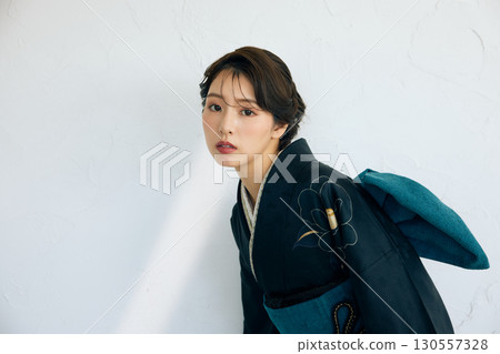 Portrait of an elegant woman wearing a black furisode 130557328