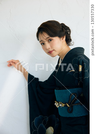 Portrait of an elegant woman wearing a black furisode Portrait of an elegant woman wearing a black furisode 130557330