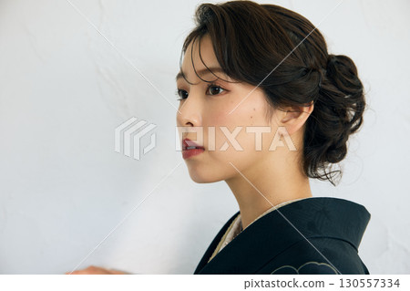 Portrait of an elegant woman wearing a black furisode Portrait of an elegant woman wearing a black furisode 130557334
