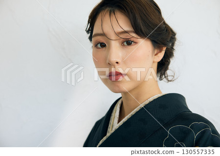 Portrait of an elegant woman wearing a black furisode Portrait of an elegant woman wearing a black furisode 130557335