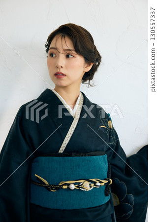Portrait of an elegant woman wearing a black furisode 130557337