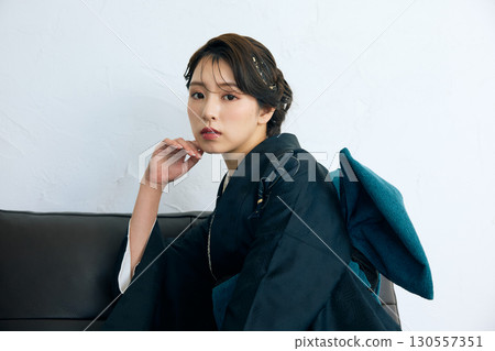 Portrait of an elegant woman wearing a black furisode 130557351