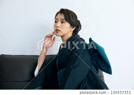 Portrait of an elegant woman wearing a black furisode Portrait of an elegant woman wearing a black furisode 130557353