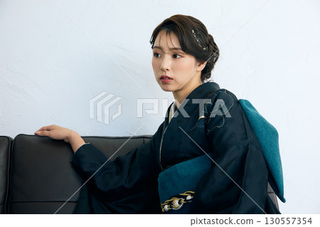 Portrait of an elegant woman wearing a black furisode 130557354