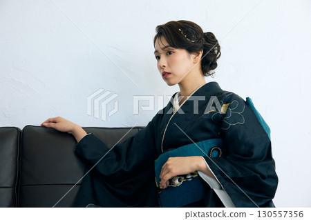 Portrait of an elegant woman wearing a black furisode 130557356