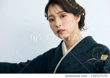 Portrait of an elegant woman wearing a black furisode Portrait of an elegant woman wearing a black furisode 130557370