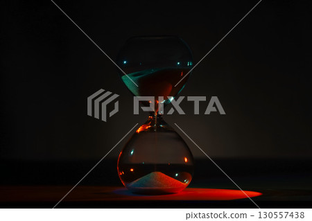 artistic glowing neon hourglass, symbolizing time and creativity. Vibrant lighting against a dark minimalist backdrop. Concepts of time management, life balance, and artistic design. artistic glowing neon hourglass, symbolizing time and creativity. Vibrant lighting against a dark minimalist backdrop. Concepts of time management, life balance, and artistic design. 130557438