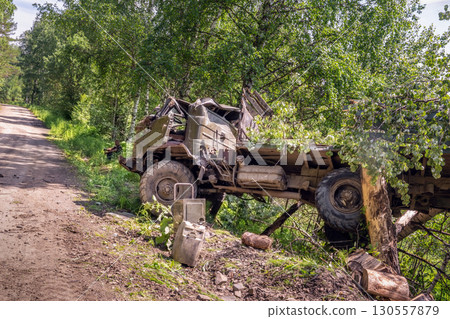 war in Ukraine. A Russian or Ukrainian military truck flew off the road as a result of a drone attack or a mine explosion or an ambush attack. Military logistics. war in Ukraine. A Russian or Ukrainian military truck flew off the road as a result of a drone attack or a mine explosion or an ambush attack. Military logistics. 130557879